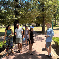 A group of people standing on a sidewalk, appears to be a guided city tour.